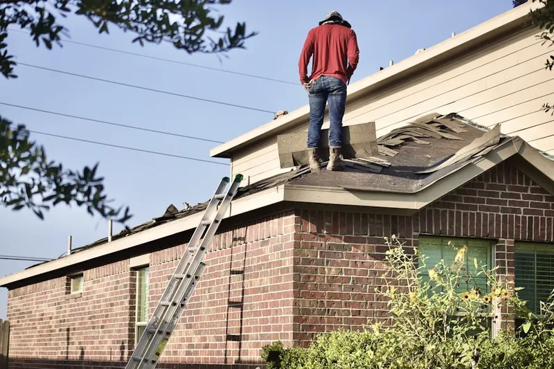 Professional roofer working on a residential roof in Seven Corners